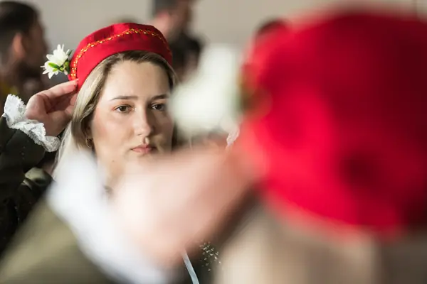 A dancer putting on her red cap