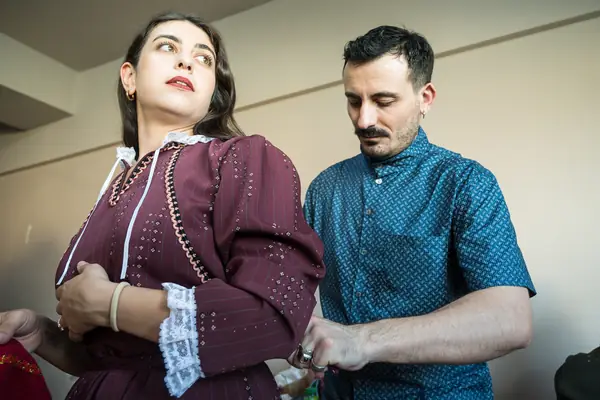 Panos adjusting a dancer's costume