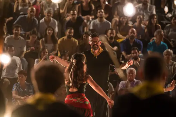 A dancer twirls in front of the audience