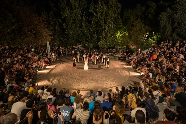 The lit circle and the audience around it, at night