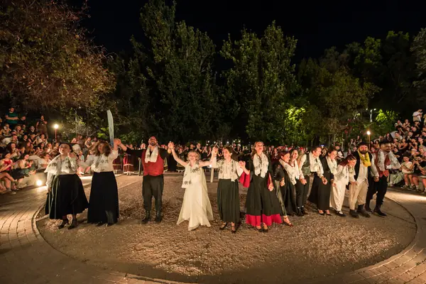 The whole group in the circle holding hands, at the end of the night